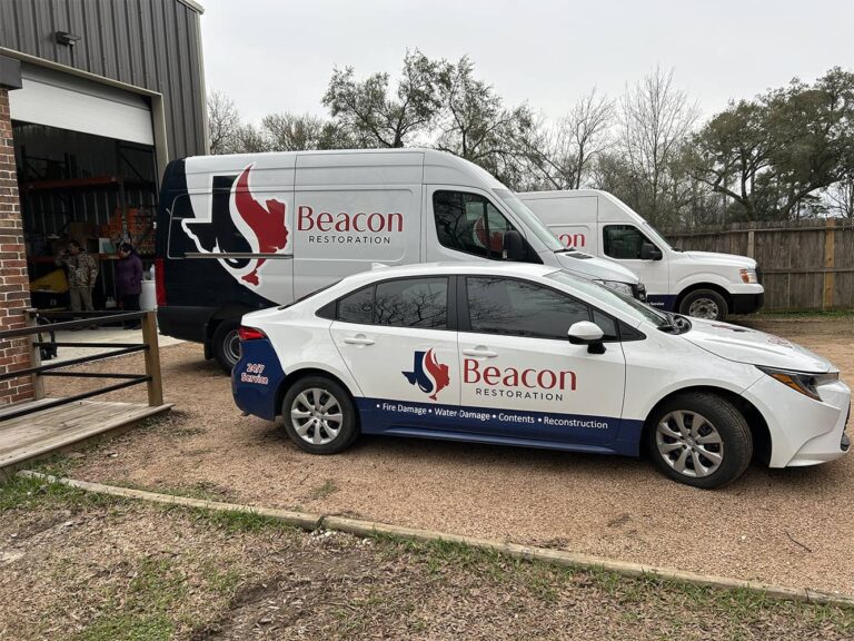 Beacon Restoration service van and car parked outside, showcasing the company’s branding for fire damage restoration services.